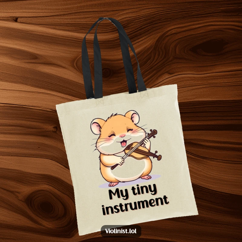 Funny hamster tote bag showing a giggling hamster intently sawing a miniature violin, perfect for carrying music accessories humorously.